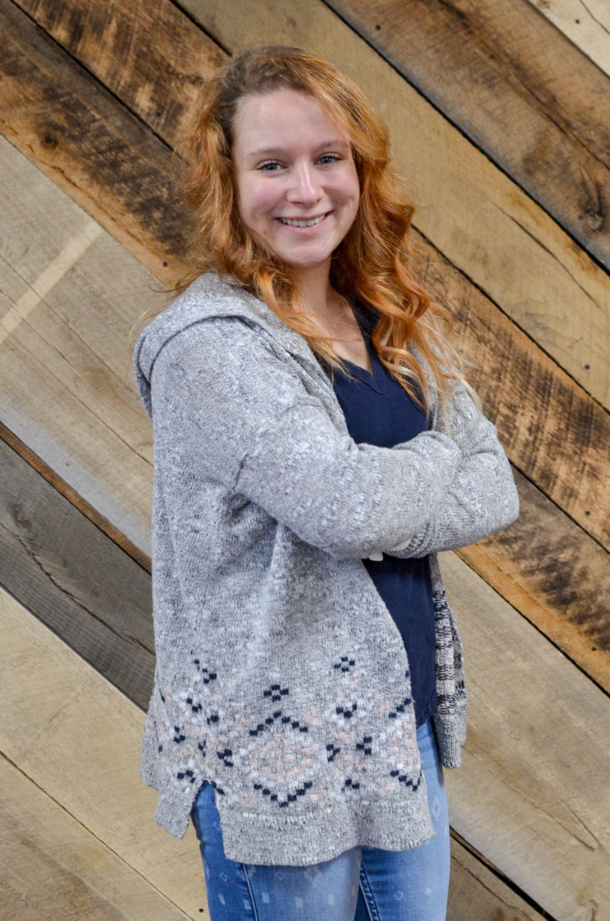 blonde haired woman standing in front of wooden wall Shepherd's Gate Church