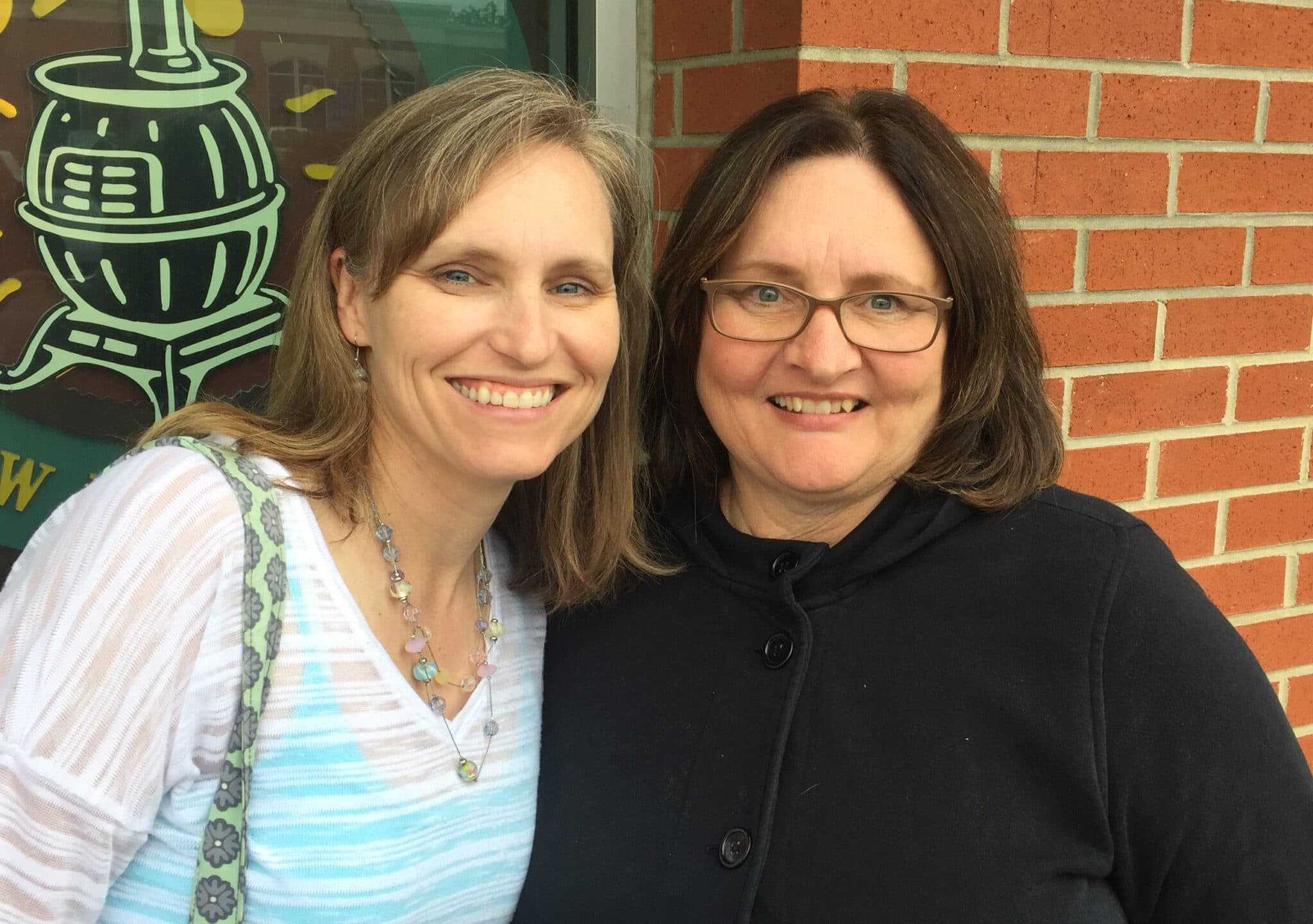 woman and daughter smiling at camera