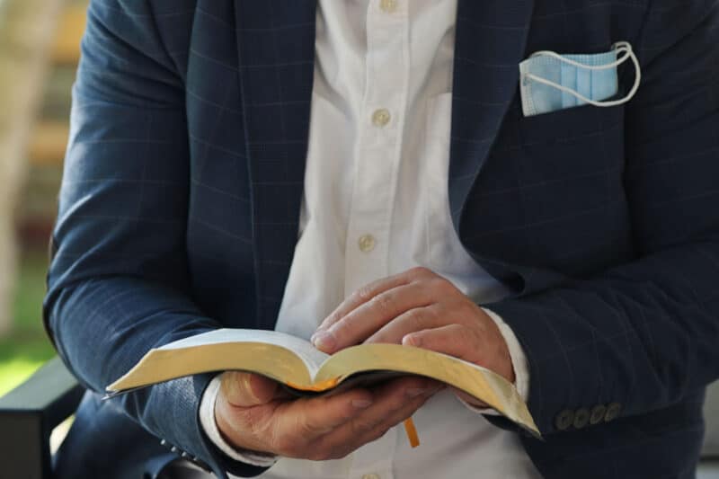 man holding open bible