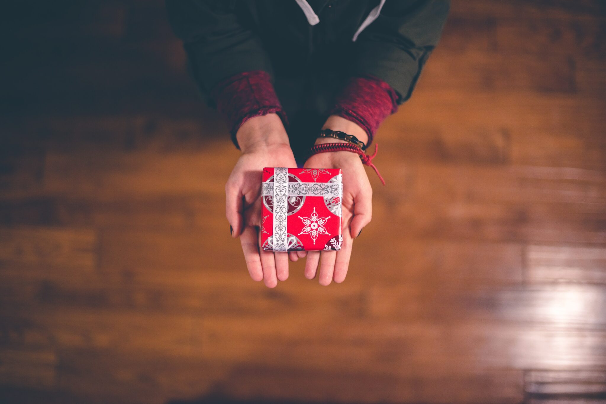 Hands holding Christmas present