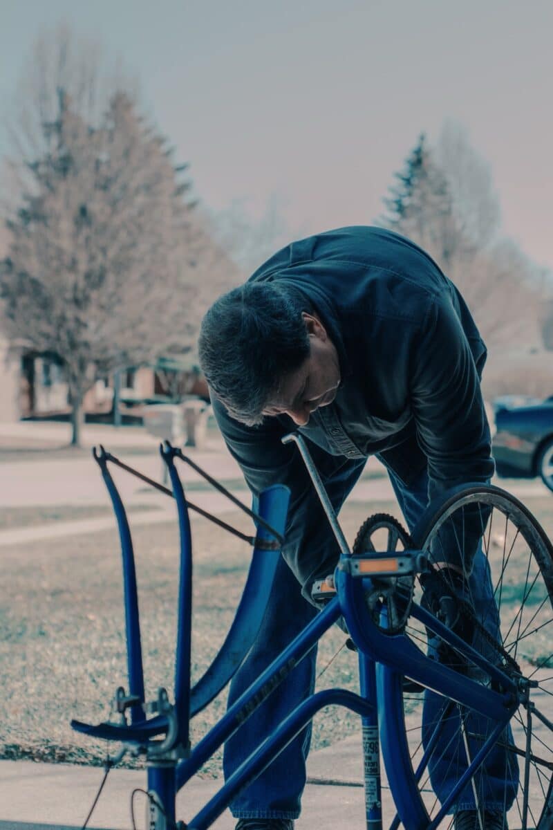 man repairing bicycle