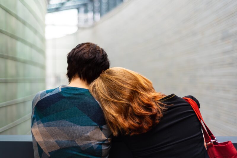 woman leaning head on man from behind