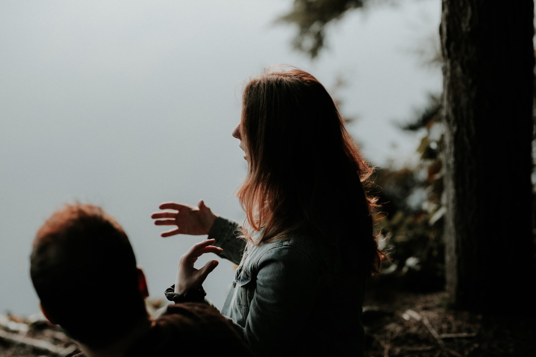 Women talking beside water