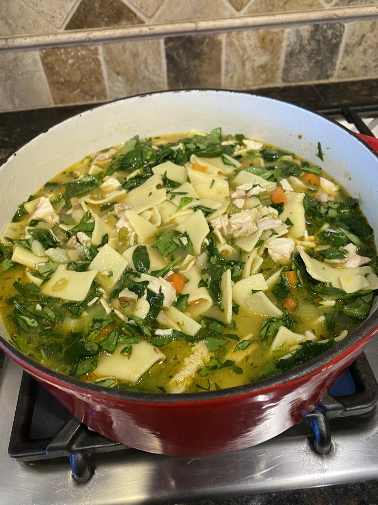 Bowl of soup with pasta and escarole.