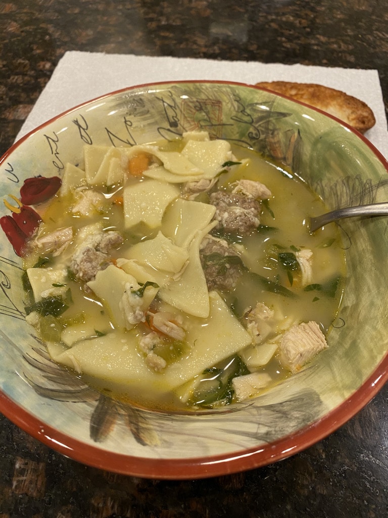 Picture of soup with mini meatballs and pasta.
