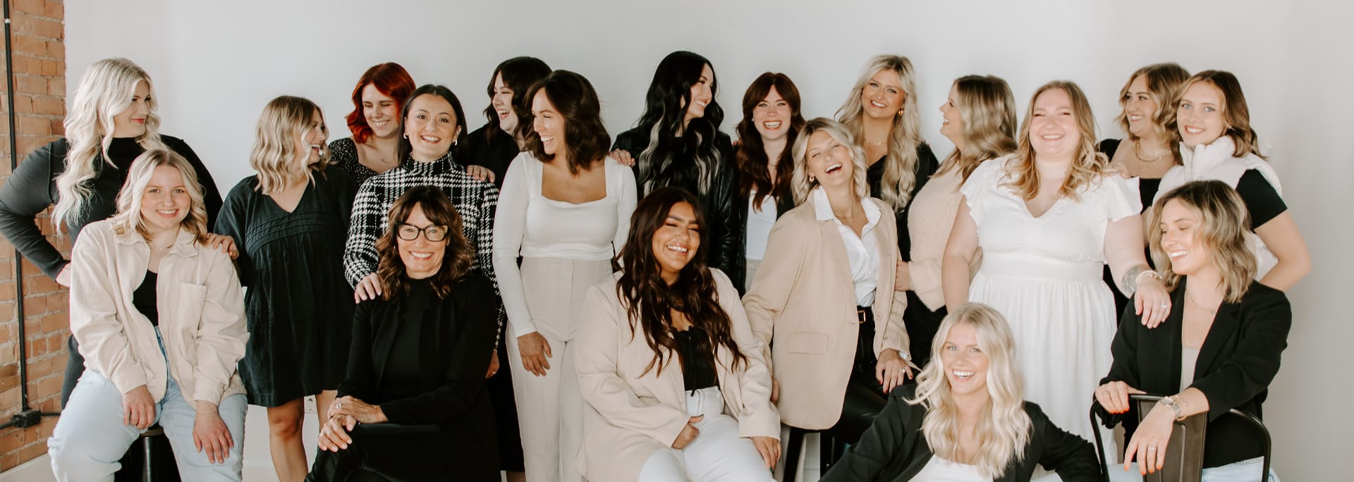 Group of women smiling for a work picture.