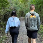 Young man and woman walking on a nature trail.