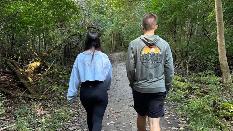 Young man and woman walking on a nature trail.