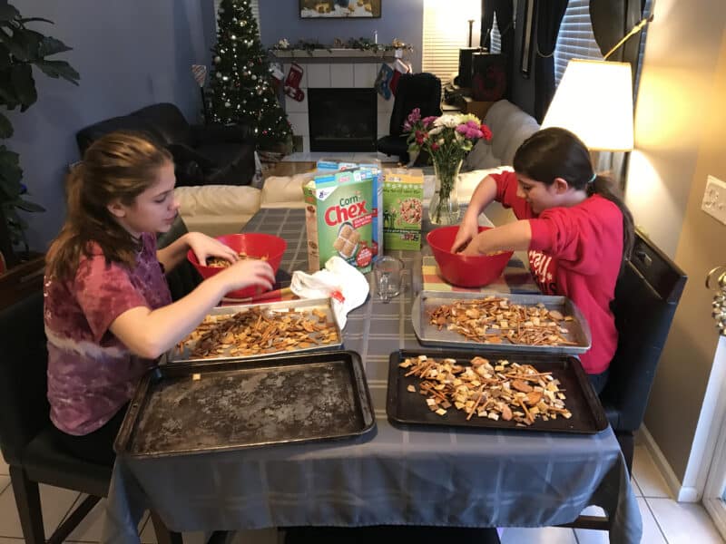 Girls making chex mix