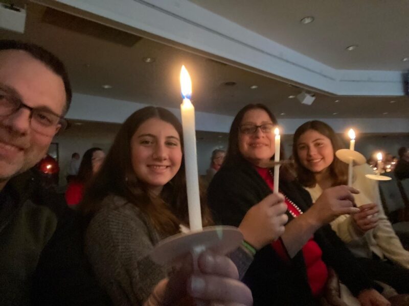 Family at church with candles.