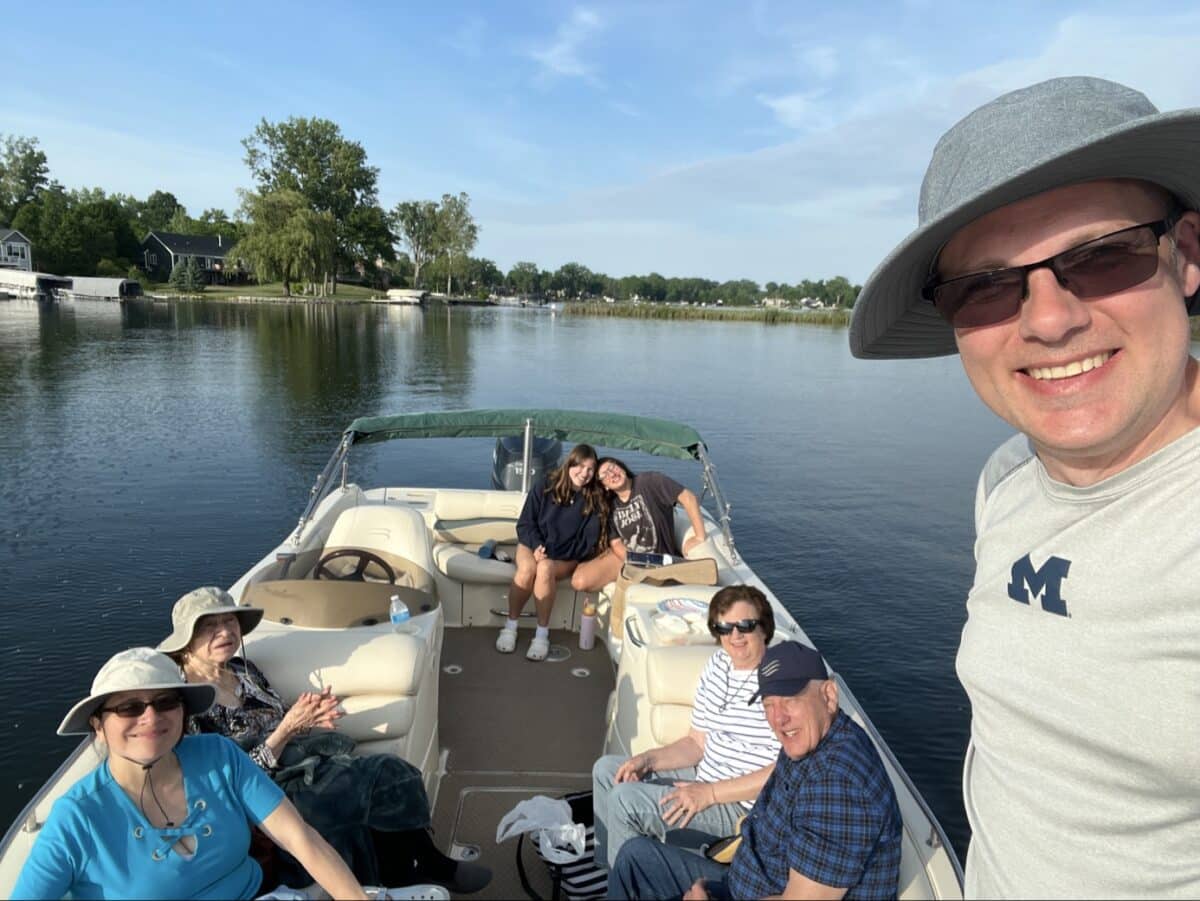Family with grandparents on a boat on a lake.