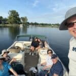 Family with grandparents on a boat on a lake.