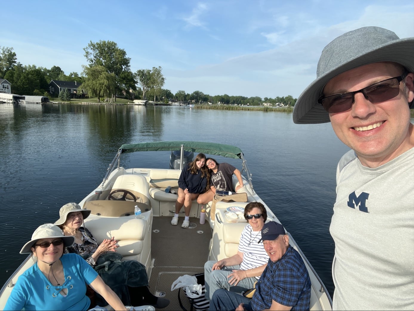 Family with grandparents on a boat on a lake.