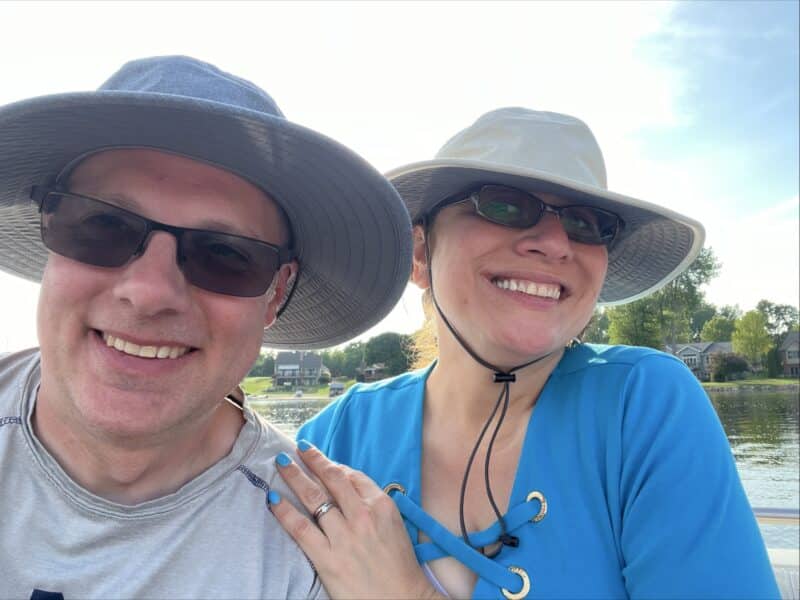 Man and wife in sun hats on the water.