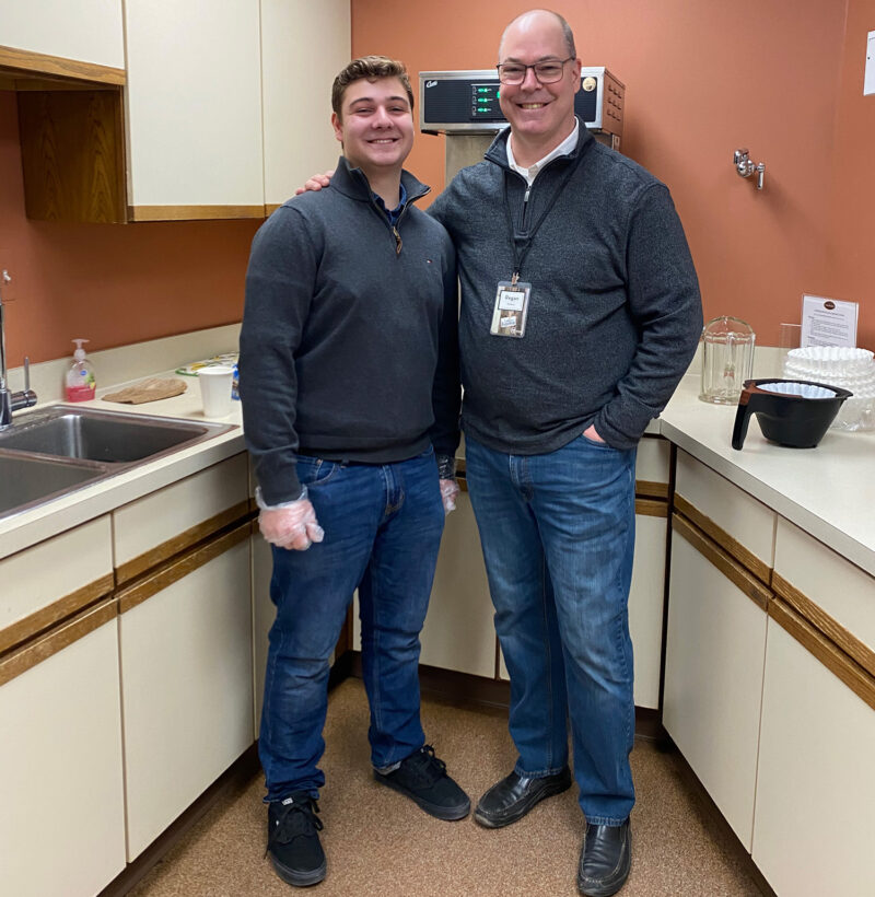 Father and son volunteering at church.