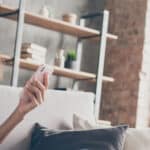Photo of lady sitting on couch holding phone