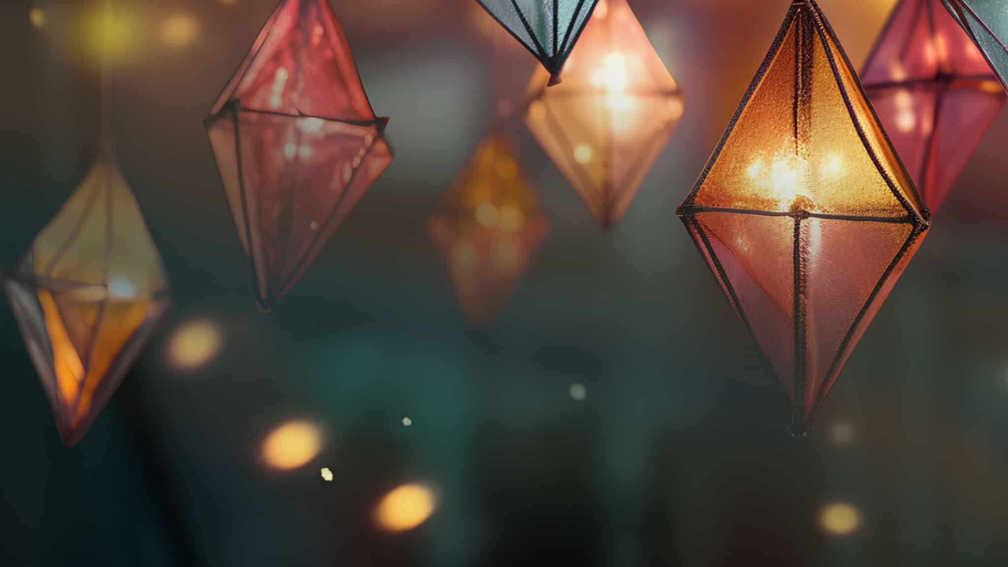 Gold, red and blue hanging lanterns with yellow christmas lights.