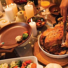 Thanksgiving food on table with candles