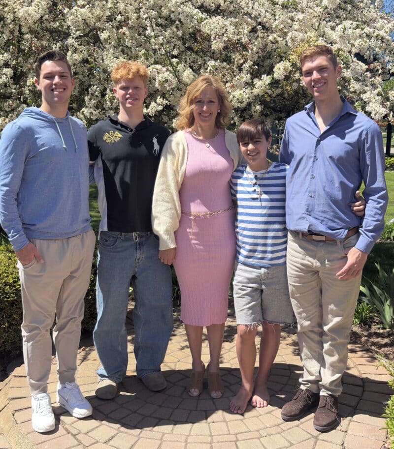 Family standing together smiling.